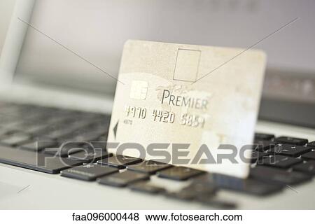 Credit card resting on laptop computer keyboard View Large Photo Image Stock Photo - Credit card resting on laptop computer keyboard. Fotosearch