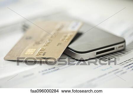 Credit card resting on smartphone View Large Photo Image Picture - Credit card resting on smartphone. Fotosearch