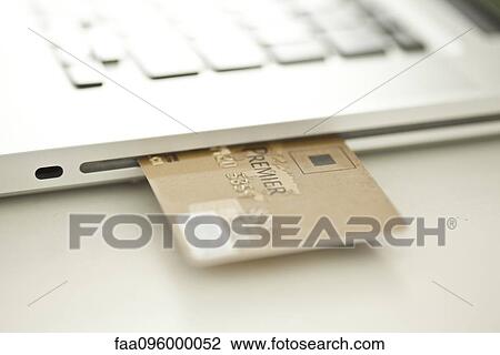 Credit card sticking out of side of laptop computer View Large Photo Image Stock Image - Credit card sticking out of side of laptop computer. Fotosearch