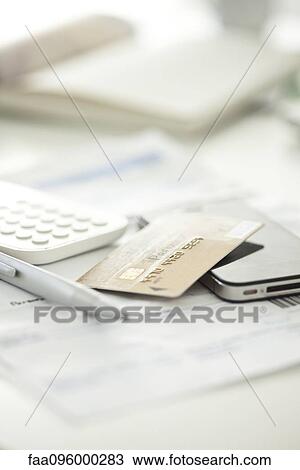 Stock Image - Credit card with smartphone and calculator. Fotosearch