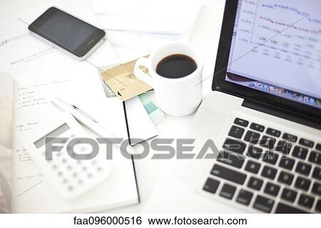 Credit cards resting near laptop computer in home office View Large Photo Image Stock Photograph - Credit cards resting near laptop computer in home office. Fotosearch