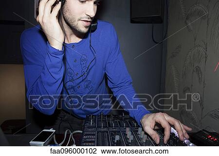 DJ using audio mixer View Large Photo Image Stock Image - DJ using audio mixer. Fotosearch