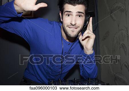 DJ using headphones and audio mixer, portrait View Large Photo Image Stock Image - DJ using headphones and audio mixer, portrait. Fotosearch