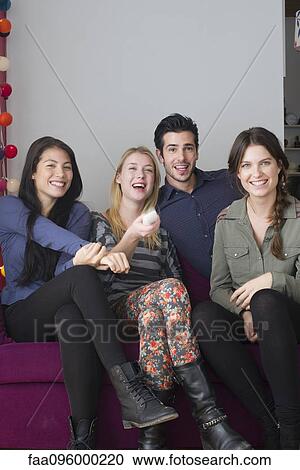 Friends watching movie at home together View Large Photo Image Stock Image - Friends watching movie at home together. Fotosearch