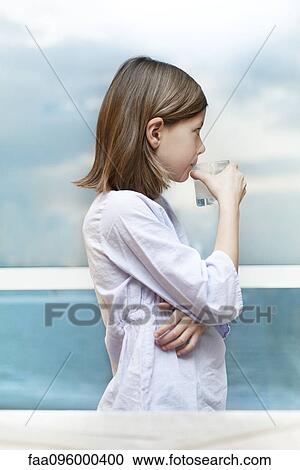 Stock Image - Girl drinking glass of milk. Fotosearch