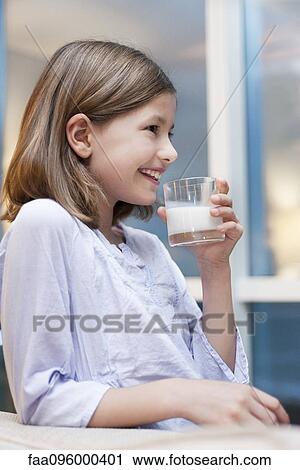 Stock Image - Girl drinking glass of milk. Fotosearch