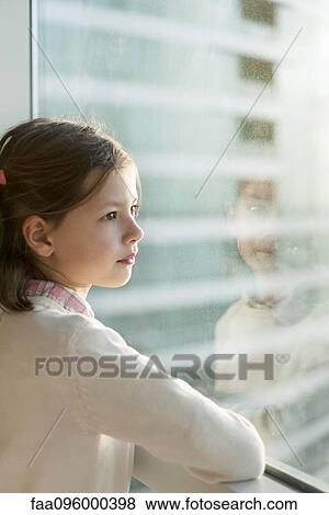 Girl looking out window, portrait View Large Photo Image Stock Photo - Girl looking out window, portrait. Fotosearch