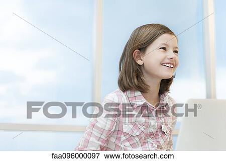 Girl using laptop computer, smiling View Large Photo Image Stock Photo - Girl using laptop computer, smiling. Fotosearch