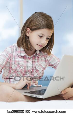 Girl using laptop computer View Large Photo Image Stock Image - Girl using laptop computer. Fotosearch