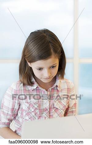 Girl using laptop computer View Large Photo Image Stock Photo - Girl using laptop computer. Fotosearch