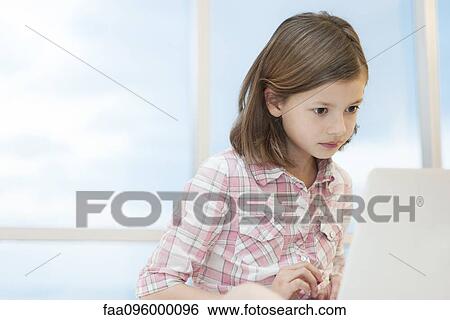 Girl using laptop computer View Large Photo Image Stock Photograph - Girl using laptop computer. Fotosearch
