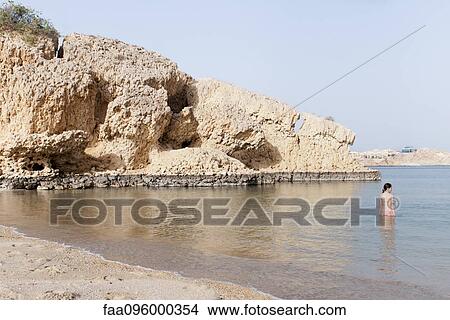 Girl wading in water at the beach View Large Photo Image Picture - Girl wading in water at the beach. Fotosearch
