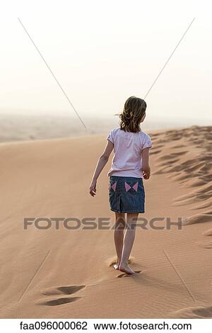 Girl walking in desert, rear view View Large Photo Image Stock Image - Girl walking in desert, rear view. Fotosearch