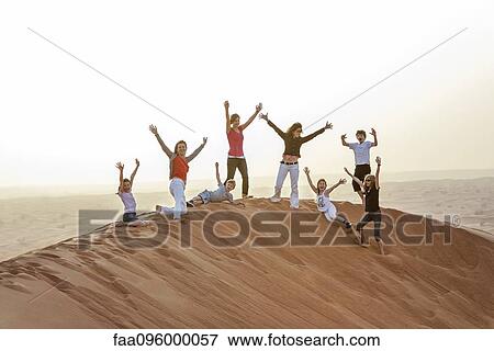 Girls playing on top of desert dune View Large Photo Image Stock Photo - Girls playing on top of desert dune. Fotosearch