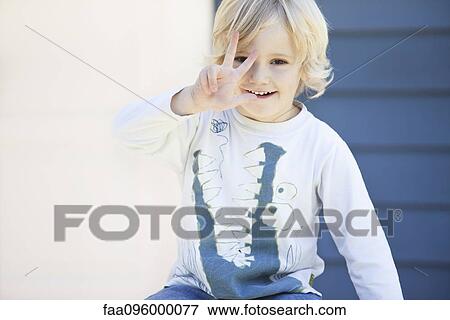 Stock Photo - Little boy holding up three fingers. Fotosearch