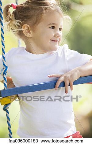 Stock Image - Little girl on jungle gym. Fotosearch