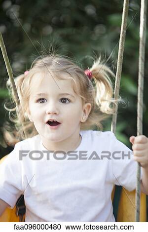 Stock Image - Little girl on swing. Fotosearch