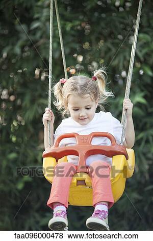 Stock Photo - Little girl on swing. Fotosearch