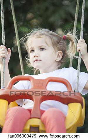Little girl on swing View Large Photo Image Stock Photo - Little girl on swing. Fotosearch