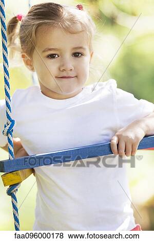 Little girl playing on jungle gym View Large Photo Image Stock Photo - Little girl playing on jungle gym. Fotosearch