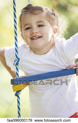 Stock Photo - Little girl playing on jungle gym. Fotosearch