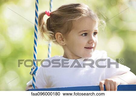 Little girl playing outdoors View Large Photo Image Stock Image - Little girl playing outdoors. Fotosearch