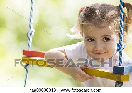 Little girl playing outdoors View Large Photo Image Stock Image - Little girl playing outdoors. Fotosearch