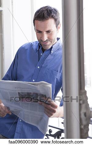 Man leaning against open window reading newspaper View Large Photo Image Stock Image - Man leaning against open window reading newspaper. Fotosearch