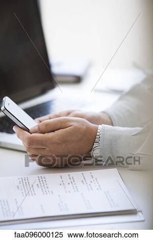 Stock Photography - Man using cell phone, cropped. Fotosearch