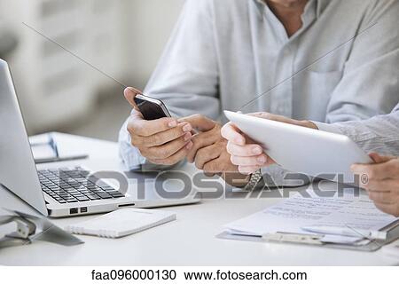 Men using wireless devices, cropped View Large Photo Image Stock Image - Men using wireless devices, cropped. Fotosearch