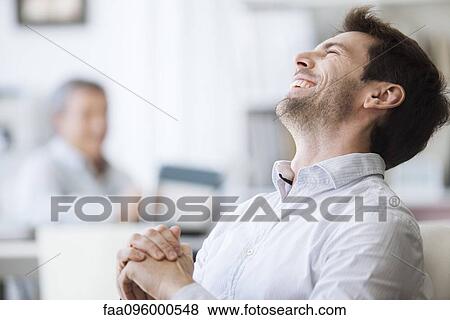 Stock Photo - Mid-adult man laughing. Fotosearch