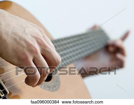 Picture - Musician playing acoustic guitar, close-up. Fotosearch