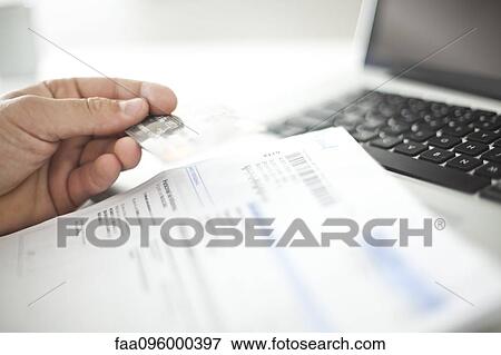 Person conducting online banking with credit card View Large Photo Image Stock Photo - Person conducting online banking with credit card. Fotosearch
