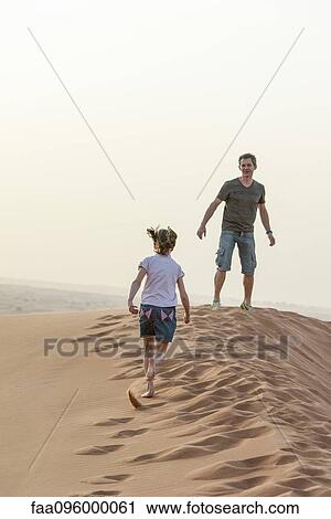 Person running up sand dune, cropped View Large Photo Image Stock Image - Person running up sand dune, cropped. Fotosearch