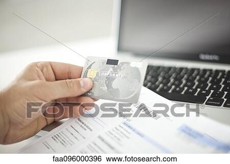 Person using credit card and laptop computer View Large Photo Image Stock Photograph - Person using credit card and laptop computer. Fotosearch