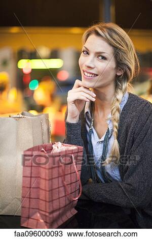 Satisfied shopper with her purchases, portrait View Large Photo Image Stock Image - Satisfied shopper with her purchases, portrait. Fotosearch