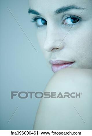 Woman, face against bare shoulder, looking at camera, portrait View Large Photo Image Stock Image - Woman, face against bare shoulder, looking at camera, portrait. Fotosearch