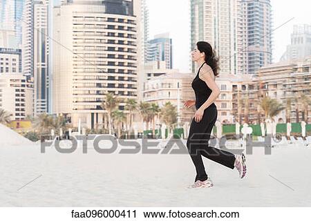 Woman jogging on beach View Large Photo Image Stock Image - Woman jogging on beach. Fotosearch