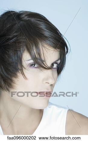 Stock Image - Woman, looking at camera, portrait. Fotosearch