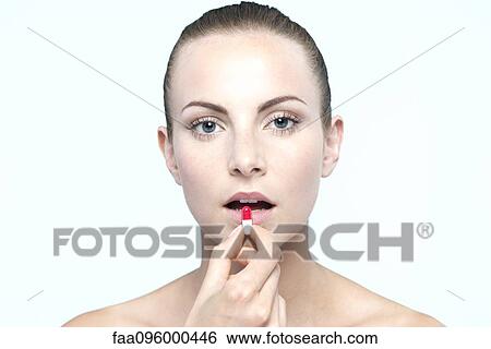 Woman preparing to take capsule View Large Photo Image Stock Photograph - Woman preparing to take capsule. Fotosearch