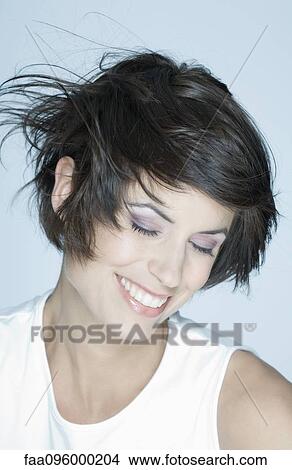 Picture - Woman smiling, hair blowing. Fotosearch
