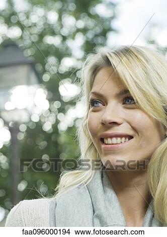 Woman smiling outdoors, portrait View Large Photo Image Picture - Woman smiling outdoors, portrait. Fotosearch