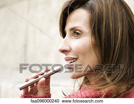 Woman smoking electronic cigarette, profile View Large Photo Image Stock Image - Woman smoking electronic cigarette, profile. Fotosearch