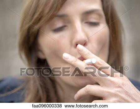 Woman smoking electronic cigarette View Large Photo Image Stock Photo - Woman smoking electronic cigarette. Fotosearch