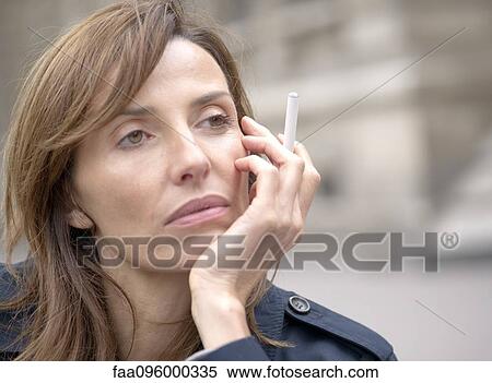 Woman smoking electronic cigarette outdoors View Large Photo Image Stock Photography - Woman smoking electronic cigarette outdoors. Fotosearch
