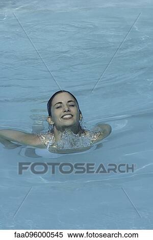 Woman swimming in pool, eyes closed View Large Photo Image Stock Photography - Woman swimming in pool, eyes closed. Fotosearch