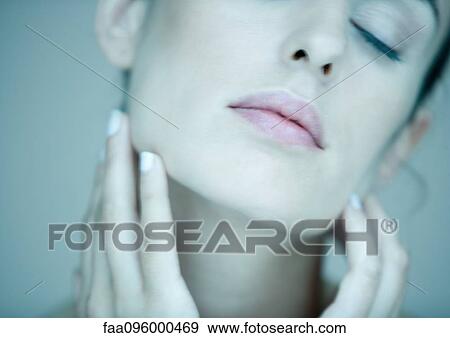 Stock Photo - Woman touching face, eyes closed, portrait, partial view. Fotosearch