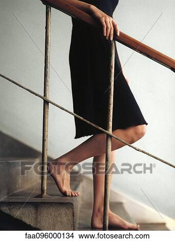 Woman walking downstairs barefoot, chest down View Large Photo Image Picture - Woman walking downstairs barefoot, chest down. Fotosearch