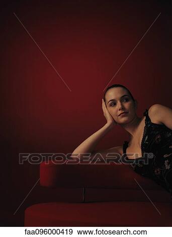 Woman wearing dress, leaning on elbow View Large Photo Image Stock Photo - Woman wearing dress, leaning on elbow. Fotosearch