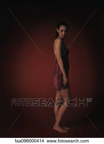Woman wearing nightgown, looking at camera, full length portrait View Large Photo Image Picture - Woman wearing nightgown, looking at camera, full length portrait. Fotosearch